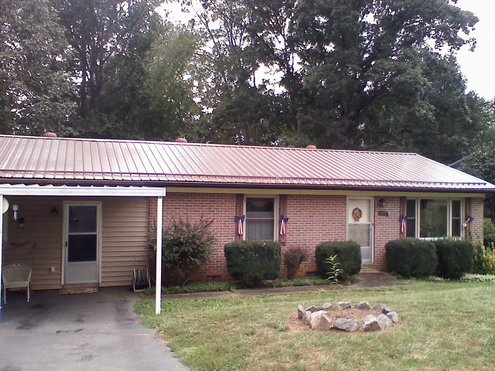 Bronze metal roof and carport on a brick ranch home — Roof Repair work by our crew in Scotts Valley